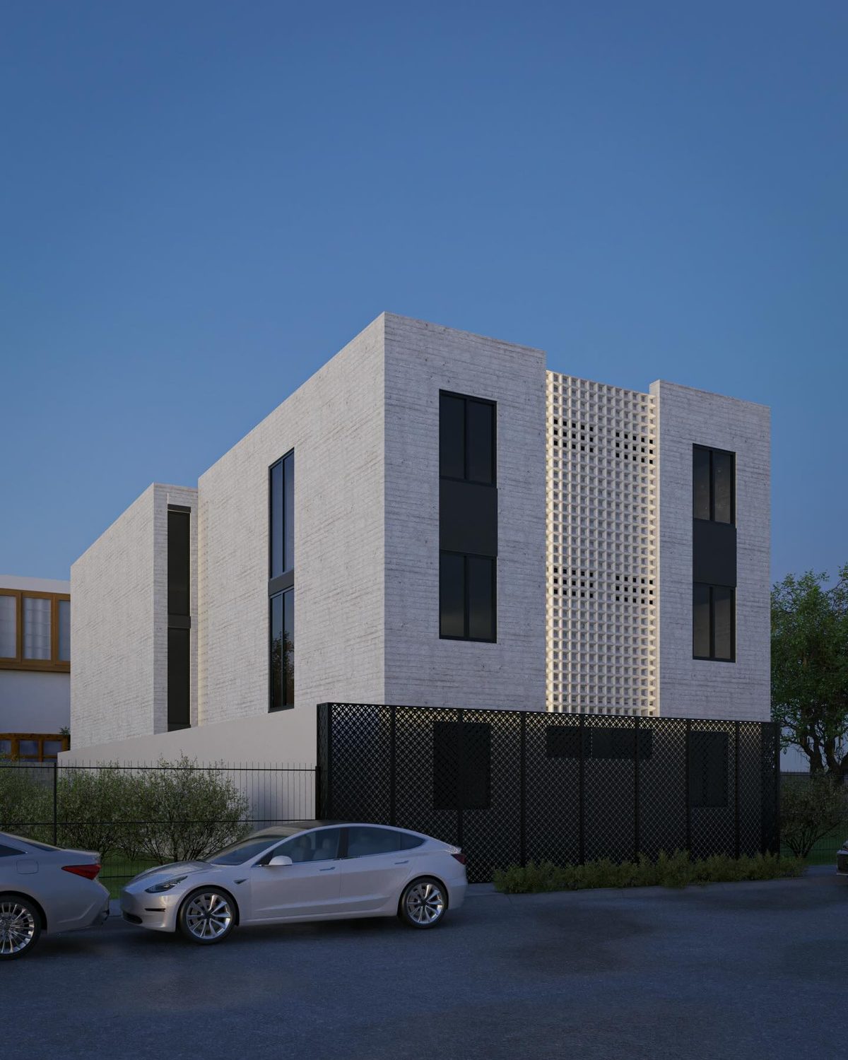 Nuevo Sur Apartments: fachada de volúmenes blancos con celosía perforada.